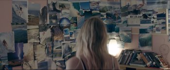Movie still from “The Tribes of Palos Verdes” (2017), directed by Brendan Malloy – A woman standing in front of a wall covered in pictures; Wide shot, Overhead angle