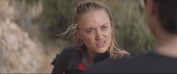 Movie still from “The Tribes of Palos Verdes” (2017), directed by Brendan Malloy – A person in a wetsuit on a surfboard; Close Up shot, Over the shoulder angle