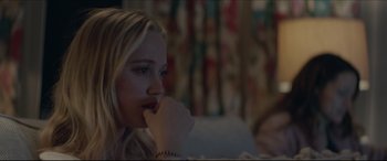 Movie still from “The Tribes of Palos Verdes” (2017), directed by Brendan Malloy – A young blonde woman sitting on top of a couch; Close Up shot, Over the shoulder angle