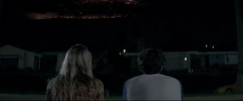 Movie still from “The Tribes of Palos Verdes” (2017), directed by Brendan Malloy – A man and a woman sitting in front of each other at night; Wide shot, Over the shoulder angle