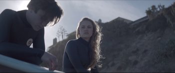 Movie still from “The Tribes of Palos Verdes” (2017), directed by Brendan Malloy – A woman with long blonde hair standing in front of a hill; Medium shot, Over the shoulder angle