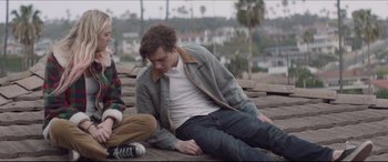 Movie still from “The Tribes of Palos Verdes” (2017), directed by Brendan Malloy – A man sitting on the ground next to another man; Medium shot, Low angle