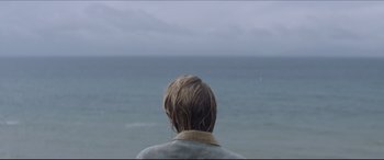 Movie still from “The Tribes of Palos Verdes” (2017), directed by Brendan Malloy – A man with wet hair looking out at the ocean; Medium shot, Over the shoulder angle