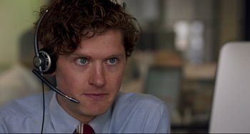 Movie still from “The Trip to Spain” (2017), directed by Michael Winterbottom – A person wearing a headset; Close Up shot, Over the shoulder angle