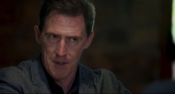 Movie still from “The Trip to Spain” (2017), directed by Michael Winterbottom – A person wearing a jacket; Close Up shot, Over the shoulder angle