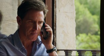 Movie still from “The Trip to Spain” (2017), directed by Michael Winterbottom – A person talking on a cell phone; Close Up shot, Low angle