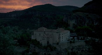 Movie still from “The Trip to Spain” (2017), directed by Michael Winterbottom – An old building on top of a hill at night; Extreme Wide shot, High angle