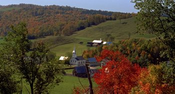 Movie still from “The Trouble with Harry” (1955), directed by Alfred Hitchcock – A view of a farm with a church in the background; Extreme Wide shot, High angle