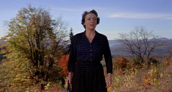 Movie still from “The Trouble with Harry” (1955), directed by Alfred Hitchcock – An older woman standing on top of a hill; Medium shot, Low angle