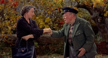 Movie still from “The Trouble with Harry” (1955), directed by Alfred Hitchcock – An older man and woman shaking hands in a park; Medium shot, High angle