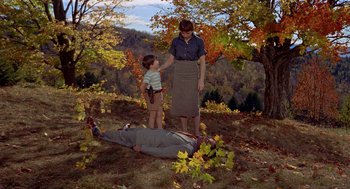 Movie still from “The Trouble with Harry” (1955), directed by Alfred Hitchcock – A woman and a child standing over a dead body; Wide shot, High angle