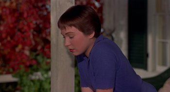 Movie still from “The Trouble with Harry” (1955), directed by Alfred Hitchcock – A boy in a blue shirt leaning against a pole; Close Up shot, High angle