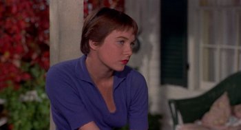 Movie still from “The Trouble with Harry” (1955), directed by Alfred Hitchcock – A woman in a blue shirt is sitting down; Close Up shot, Over the shoulder angle