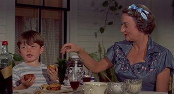 Movie still from “The Trouble with Harry” (1955), directed by Alfred Hitchcock – A woman and a boy sitting at a dinner table; Medium shot, Over the shoulder angle