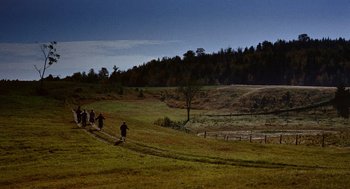 Movie still from “The Trouble with Harry” (1955), directed by Alfred Hitchcock – A group of people walking across a lush green field; Extreme Wide shot, High angle