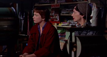 Movie still from “The Trouble with Harry” (1955), directed by Alfred Hitchcock – Two people sitting in a room next to each other; Medium shot, Over the shoulder angle