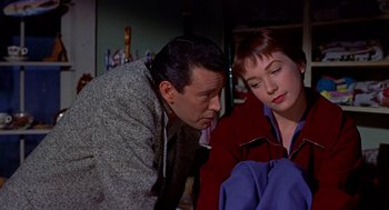 Movie still from “The Trouble with Harry” (1955), directed by Alfred Hitchcock – A man and a woman looking at each other in a room; Medium shot, Over the shoulder angle