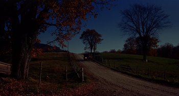 Movie still from “The Trouble with Harry” (1955), directed by Alfred Hitchcock – A car driving down a dirt road at night; Extreme Wide shot, High angle