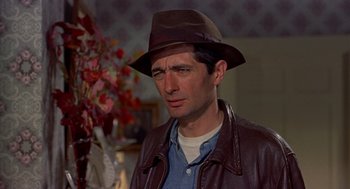 Movie still from “The Trouble with Harry” (1955), directed by Alfred Hitchcock – A man wearing a hat and a leather jacket; Close Up shot, Low angle