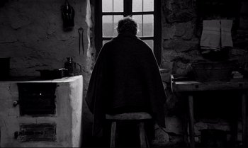 A person sitting in front of an open window