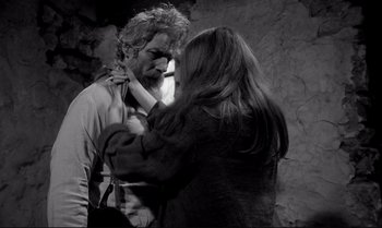 Movie still from “The Turin Horse” (2011), directed by Ágnes Hranitzky – A man and a woman face each other in a black - and - white photo; Medium shot, Over the shoulder angle