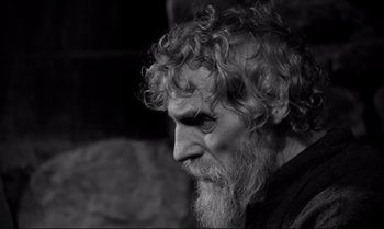 Movie still from “The Turin Horse” (2011), directed by Ágnes Hranitzky – An old man with a long white beard; Close Up shot, Over the shoulder angle