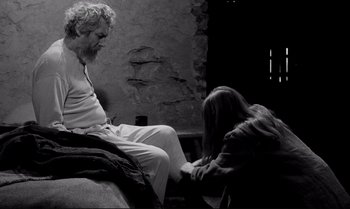 Movie still from “The Turin Horse” (2011), directed by Ágnes Hranitzky – An old man sitting next to a young woman; Wide shot, Over the shoulder angle