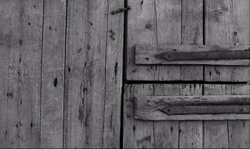 Movie still from “The Turin Horse” (2011), directed by Ágnes Hranitzky – View of a wooden door; Extreme Close Up shot, Overhead angle