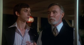 Movie still from “The Turning Point” (1977), directed by Herbert Ross – A man and a boy standing next to each other holding drinks; Close Up shot, Low angle