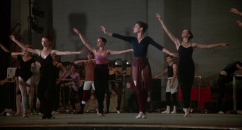 Movie still from “The Turning Point” (1977), directed by Herbert Ross – A group of people standing on a stage with their arms in the air; Wide shot, Low angle