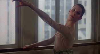 Movie still from “The Turning Point” (1977), directed by Herbert Ross – A young woman is stretching on a ballet barre; Close Up shot, Low angle
