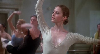 Movie still from “The Turning Point” (1977), directed by Herbert Ross – A woman in a white shirt is doing a dance move; Close Up shot, Low angle