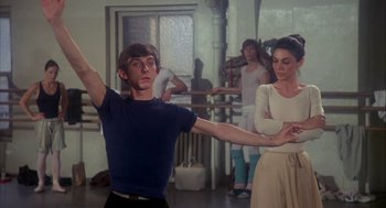 Movie still from “The Turning Point” (1977), directed by Herbert Ross – A man and a woman are dancing in front of a group of people; Medium shot, Low angle
