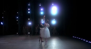 Movie still from “The Turning Point” (1977), directed by Herbert Ross – A couple of people that are dancing in a room; Wide shot, Low angle