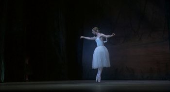 Movie still from “The Turning Point” (1977), directed by Herbert Ross – A woman in a white dress is dancing on a stage; Wide shot, Low angle