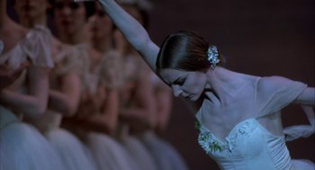 Movie still from “The Turning Point” (1977), directed by Herbert Ross – A woman in a white dress is doing a ballet move; Close Up shot, Low angle