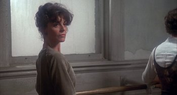Movie still from “The Turning Point” (1977), directed by Herbert Ross – A woman standing in front of a railing in front of a window; Close Up shot, Low angle