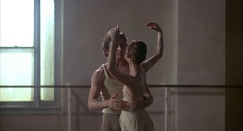 Movie still from “The Turning Point” (1977), directed by Herbert Ross – A man and a woman are dancing in a dance studio; Medium shot, Low angle