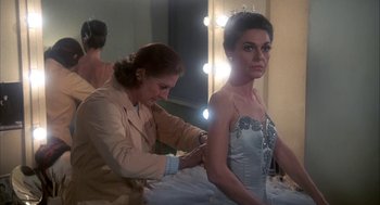Movie still from “The Turning Point” (1977), directed by Herbert Ross – A woman is getting ready for a dance; Medium shot, Over the shoulder angle