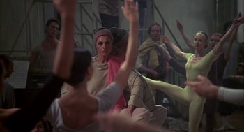 Movie still from “The Turning Point” (1977), directed by Herbert Ross – A group of people sitting in a room with their hands raised; Medium shot, High angle
