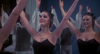 Movie still from “The Turning Point” (1977), directed by Herbert Ross – A group of people in a room with their hands raised; Close Up shot, Low angle