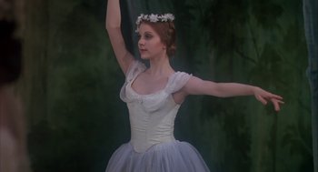 Movie still from “The Turning Point” (1977), directed by Herbert Ross – A woman in a white dress and a flower crown; Medium shot, Low angle