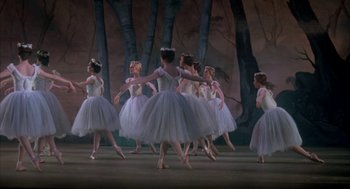 Movie still from “The Turning Point” (1977), directed by Herbert Ross – A group of ballerinas in white tutus in front of trees; Wide shot, Low angle