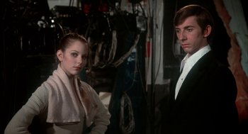 Movie still from “The Turning Point” (1977), directed by Herbert Ross – A man and a woman standing next to each other; Medium shot, Low angle