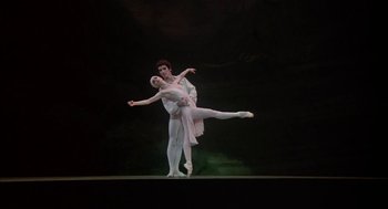 Movie still from “The Turning Point” (1977), directed by Herbert Ross – A man and a woman are dancing on a stage; Wide shot, Low angle