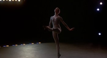 Movie still from “The Turning Point” (1977), directed by Herbert Ross – A woman in a white body suit is dancing; Medium shot, Low angle