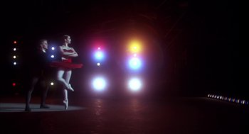 Movie still from “The Turning Point” (1977), directed by Herbert Ross – A ballet dancer is standing in front of a traffic light; Wide shot, Low angle