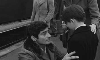 Movie still from “The Two of Us” (1967), directed by Claude Berri – A young man and a young boy looking at each other; Medium shot, Over the shoulder angle