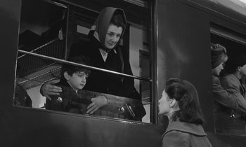 Movie still from “The Two of Us” (1967), directed by Claude Berri – A woman and a child looking out a window; Medium shot, Over the shoulder angle