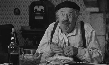 Movie still from “The Two of Us” (1967), directed by Claude Berri – An old man sitting at a table with a bowl of food; Close Up shot, High angle